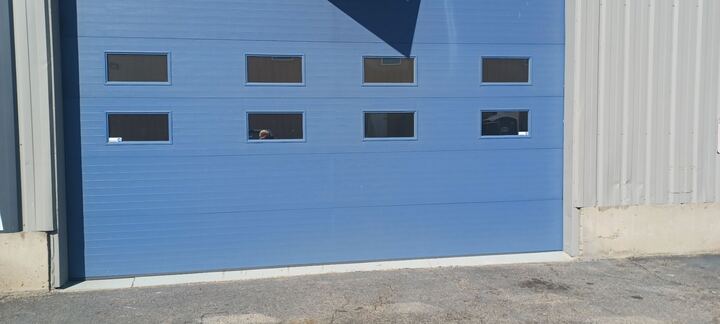 Commercial blue garage door with windows